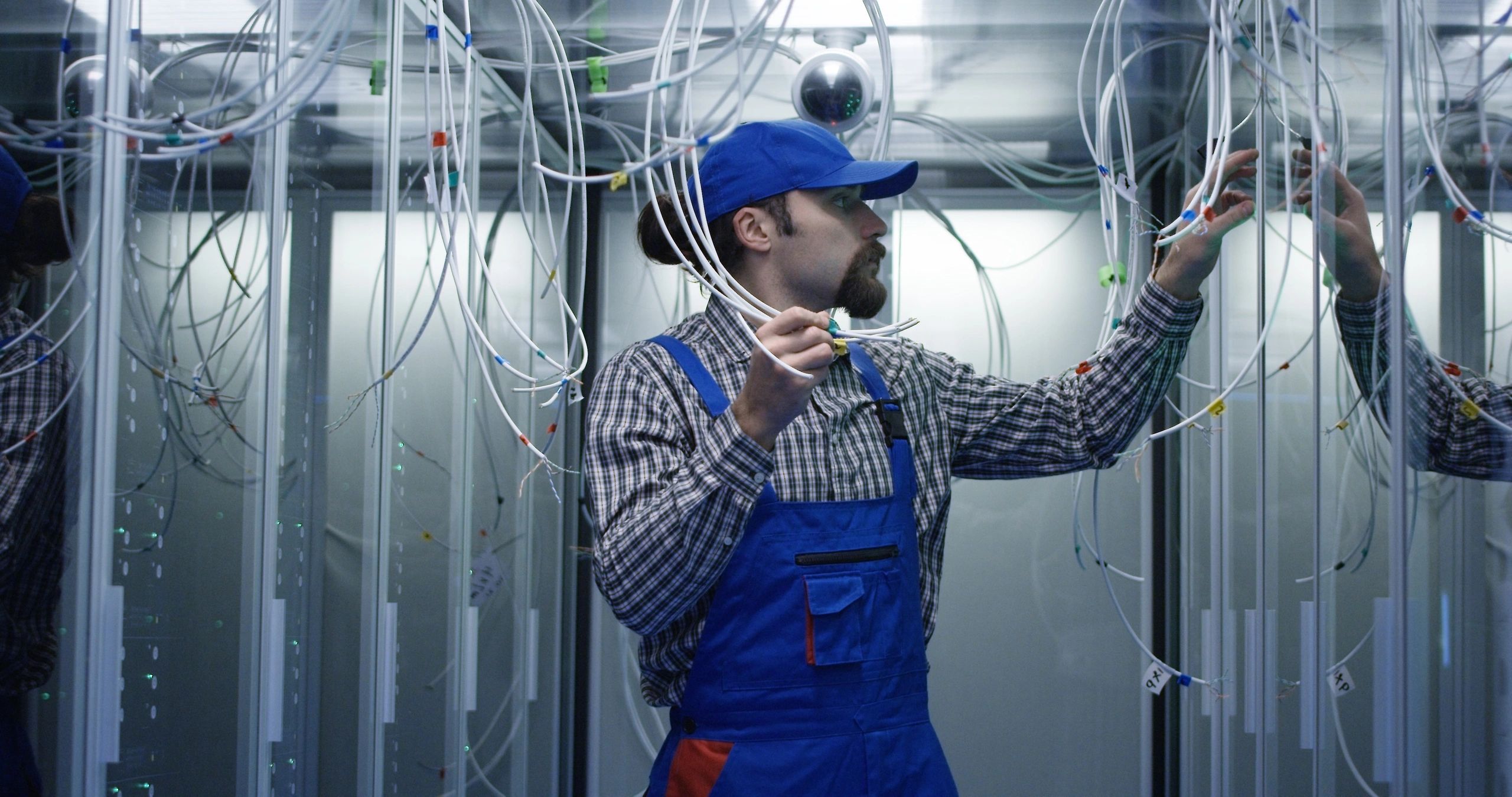 Technician working through network cabling in a rack environment