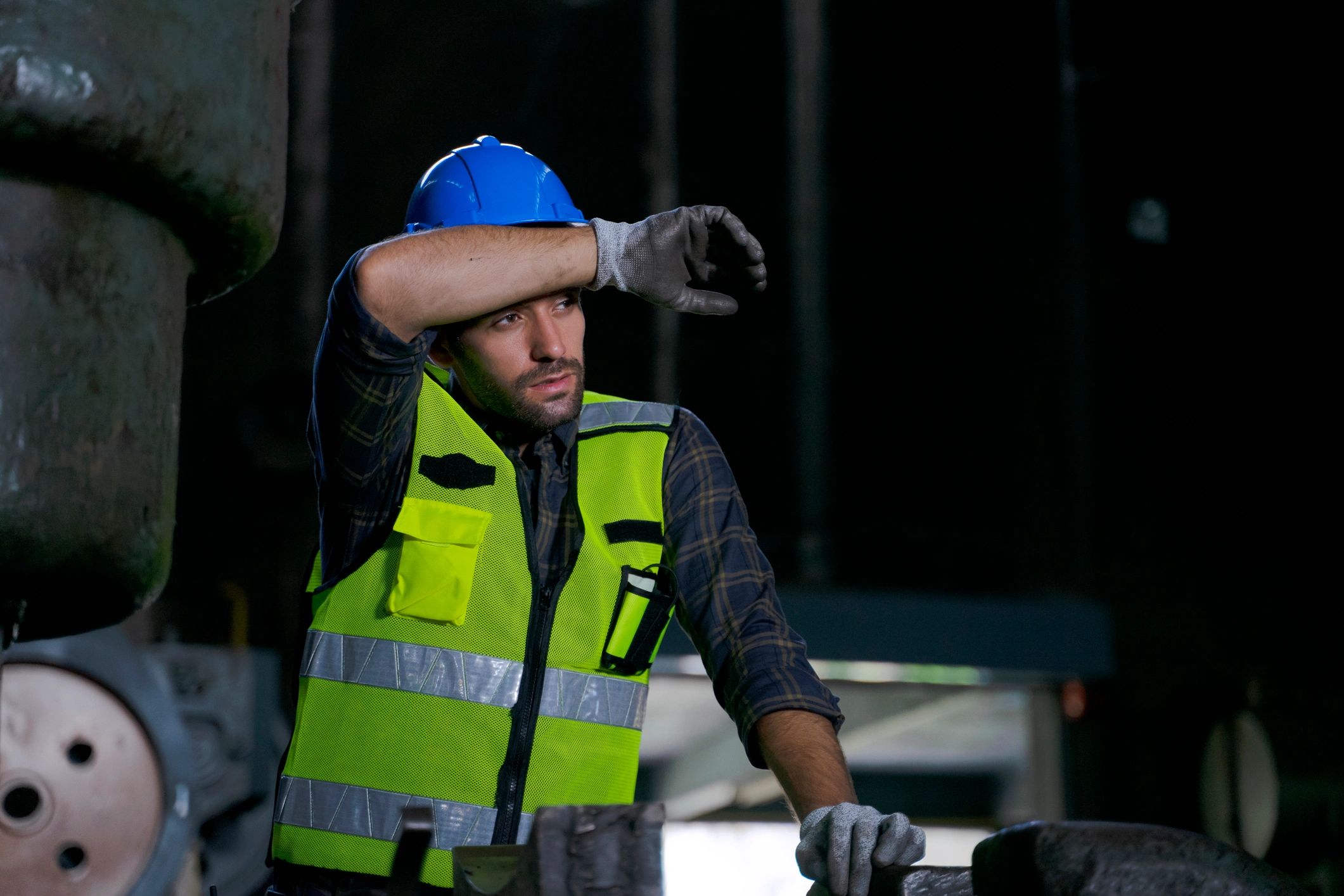 Technician wearing helmet and safety vest during field installation work