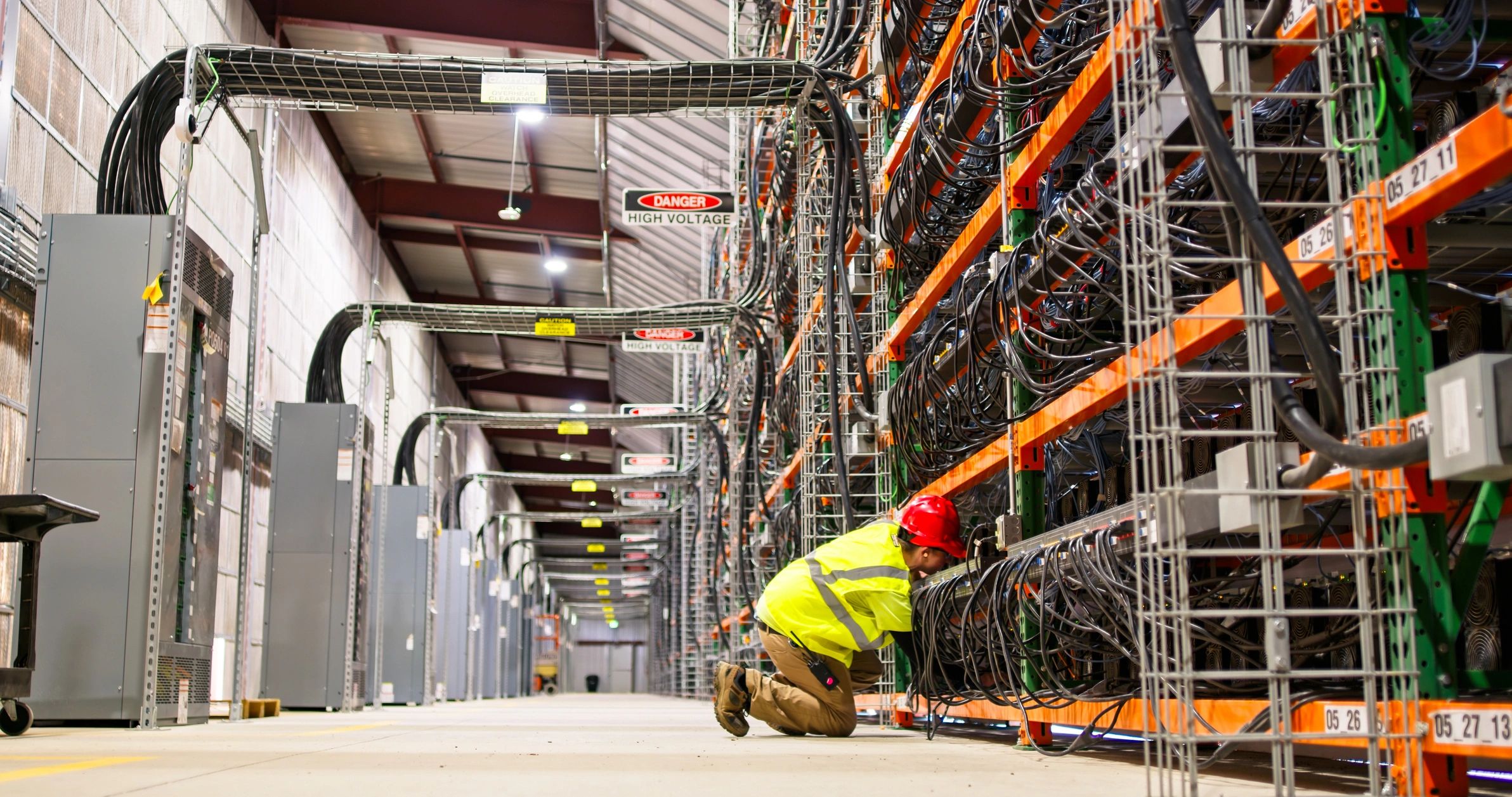 Technician working in a large server rack environment