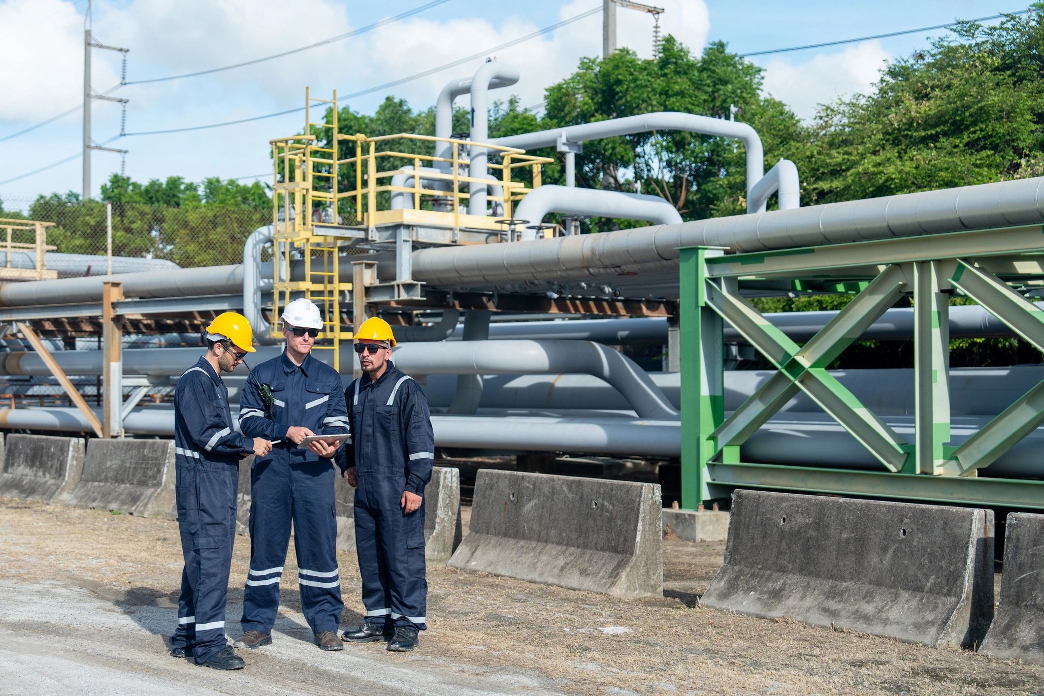 Telecom field crew wearing PPE at an active industrial work site