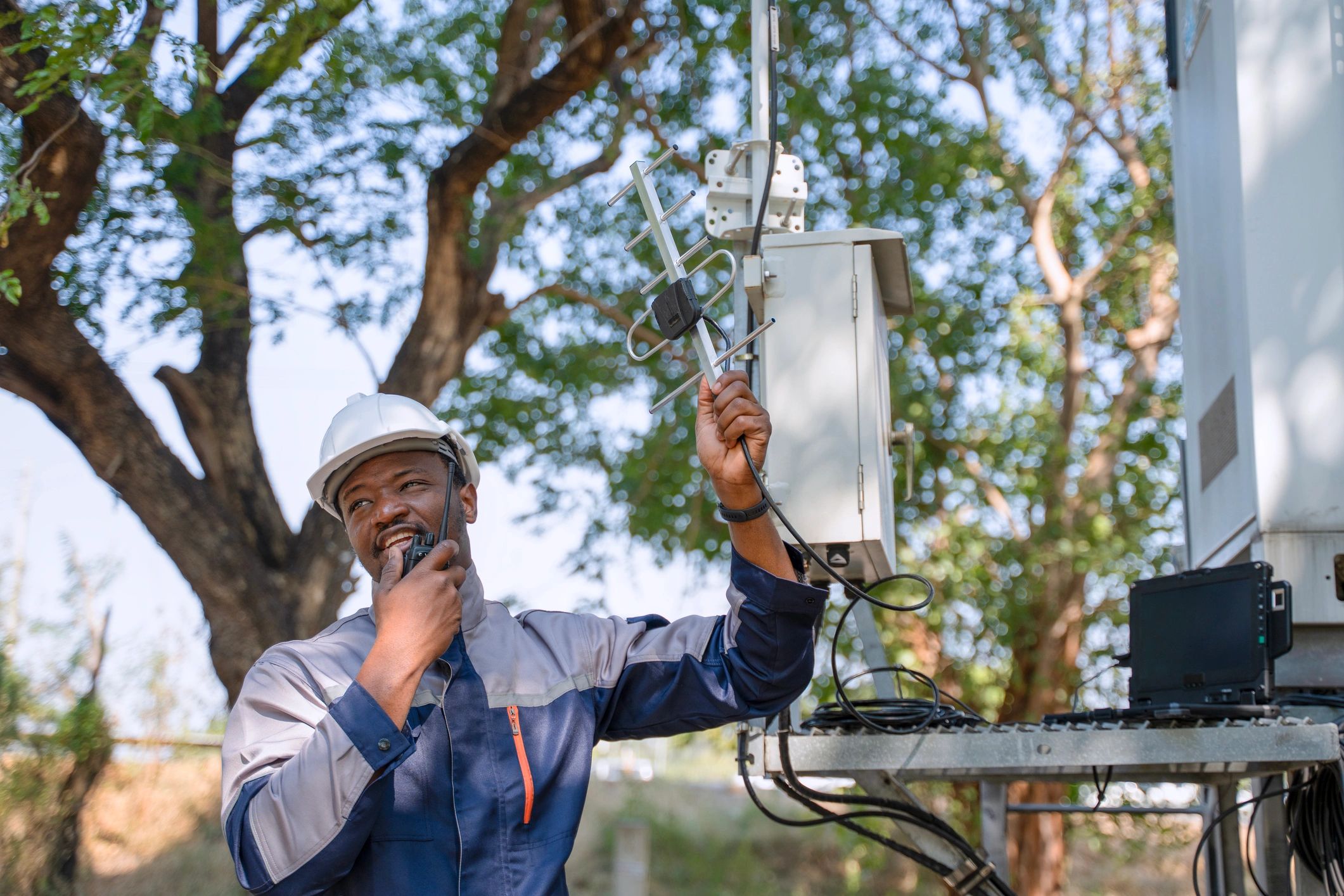 Technician inspecting communication signal equipment