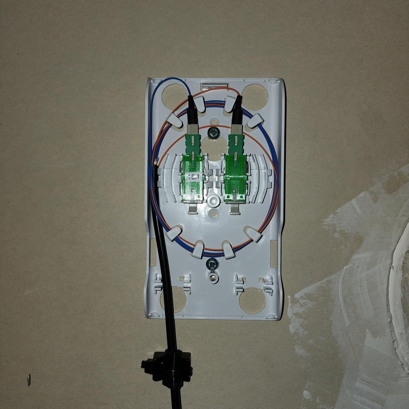 Wall-mounted fiber optic outlet with green SC/APC connectors
